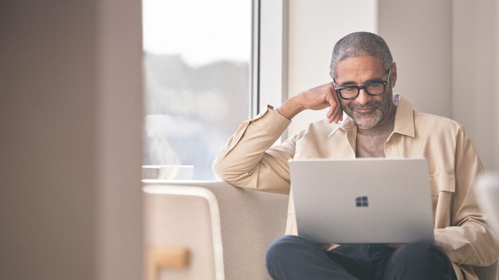 A person working on a laptop in an office.